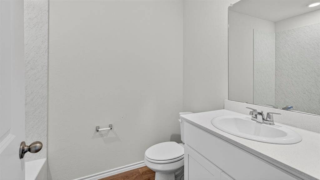 6053 Freedom Drive, Lindale, TX 75771 Bathroom vanity with integrated sink, chrome faucet, and expansive mirror