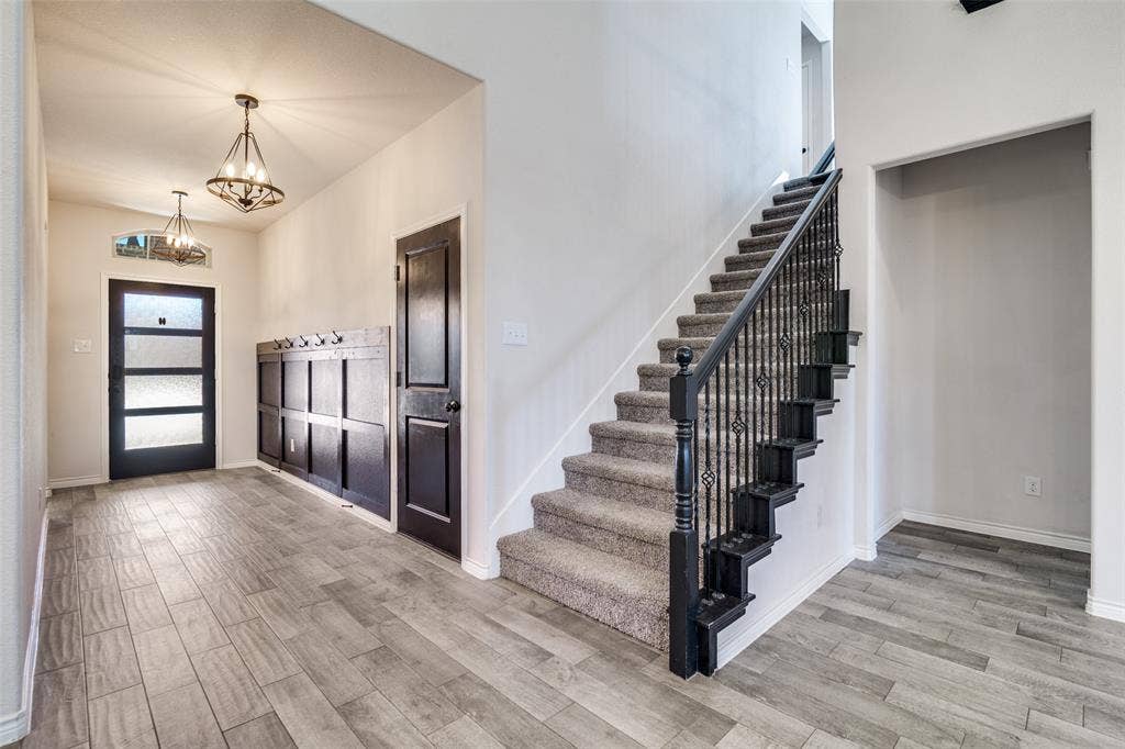3094 Maverick Drive, Heath, TX 75126 Custom wood work in entry as well as wood like flooring throughout.