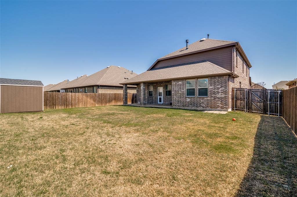 3094 Maverick Drive, Heath, TX 75126 Large back yard with a covered patio and storage shed