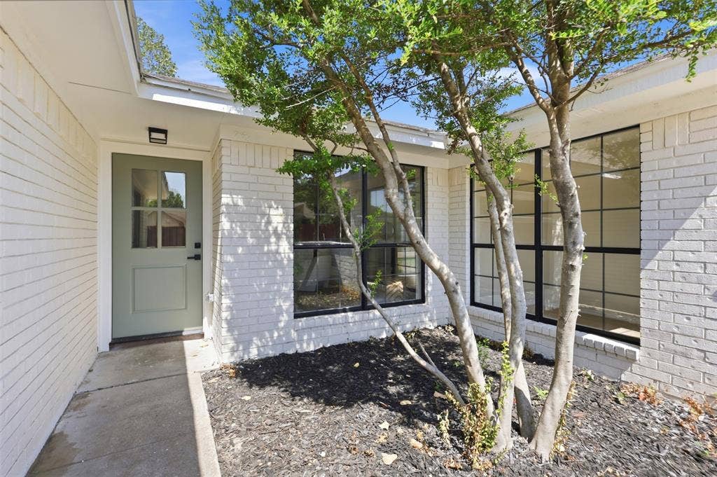 7321 Burke Circle, Plano, TX 75025 White painted brick exterior with a sage green front door