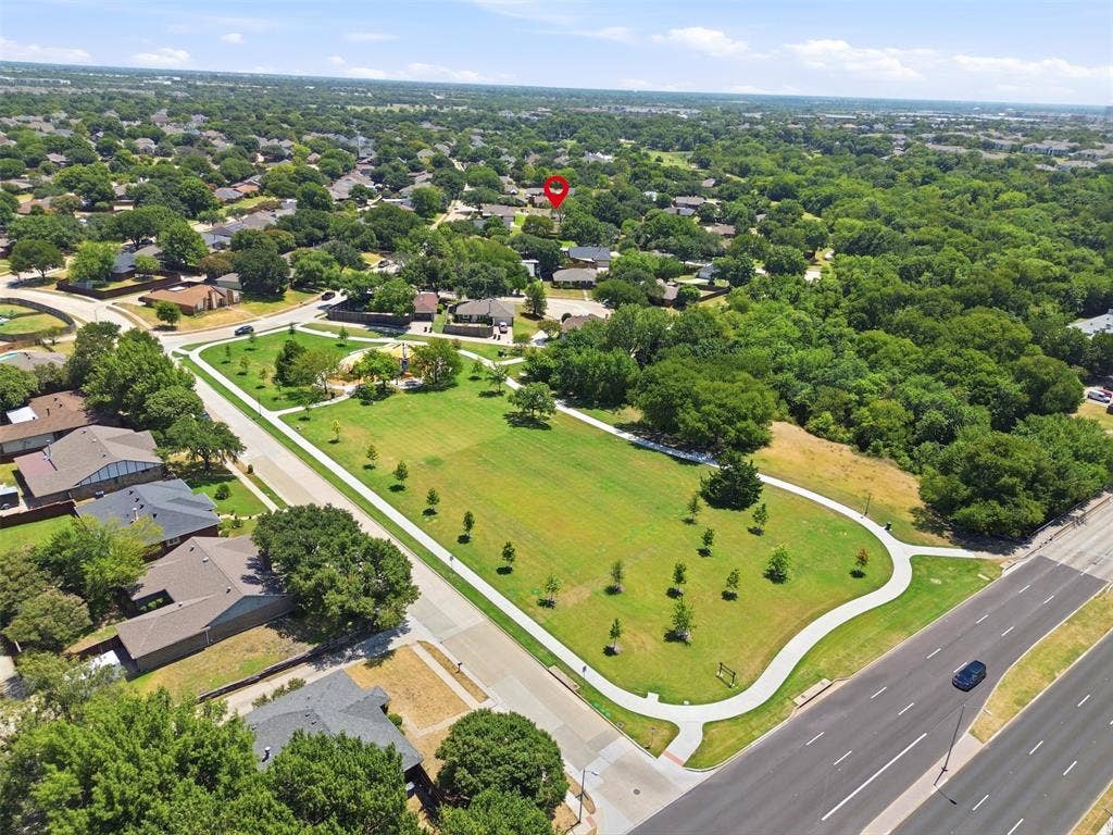 7321 Burke Circle, Plano, TX 75025 Aerial perspective featuring a public park, mature trees, and residential properties