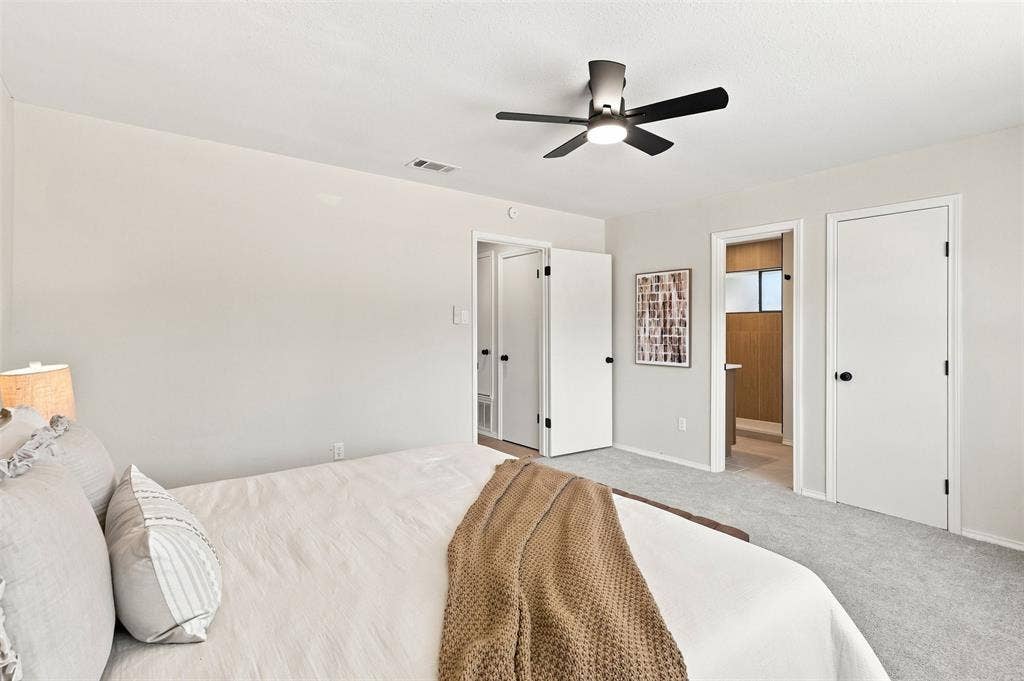 7321 Burke Circle, Plano, TX 75025 Carpeted flooring, light-toned walls, ceiling fan, and multiple white doors with black hardware
