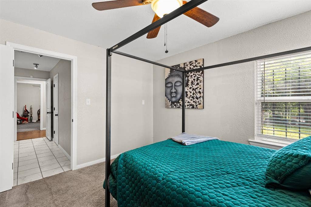 3700 Charlton Avenue, Waco, TX 76711 Carpeted bedroom featuring a ceiling fan with light fixture, window with blinds, and white painted walls