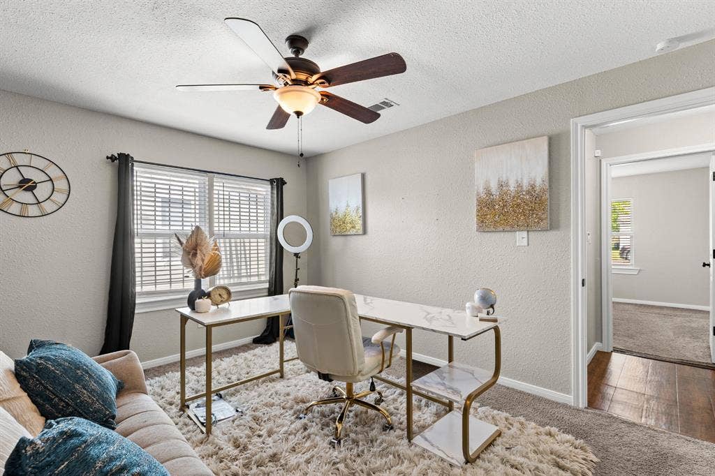 3700 Charlton Avenue, Waco, TX 76711 Room featuring light-colored walls, window with blinds, and a dark-bladed ceiling fan with integrated lighting