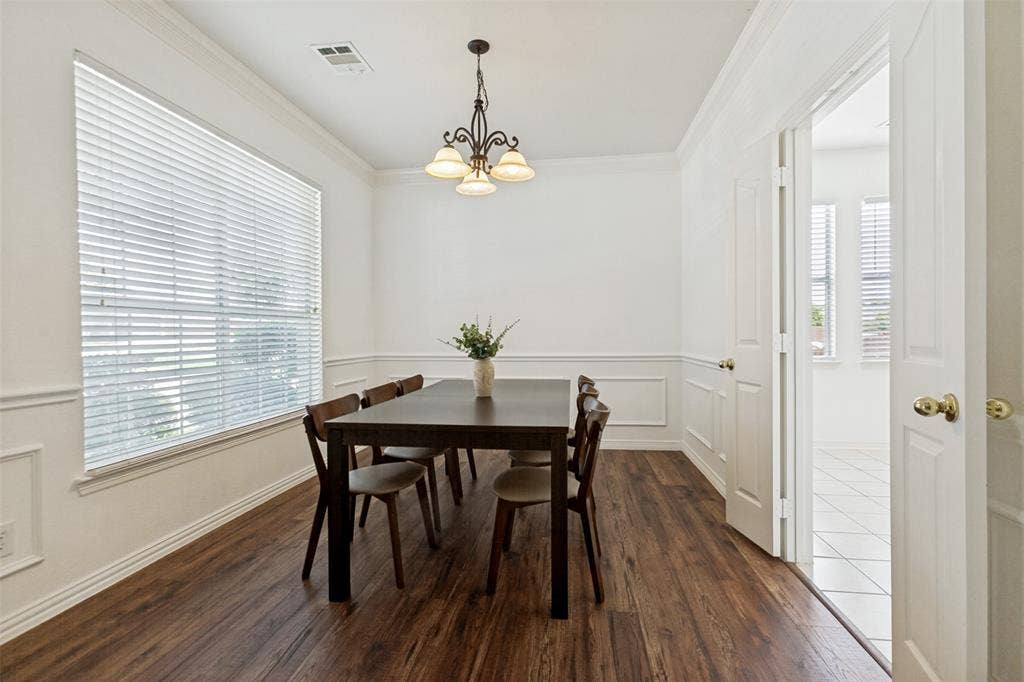 162 Shelby Trace, Murphy, TX 75094 Formal dining room with new LVP flooring and custom wainscoting