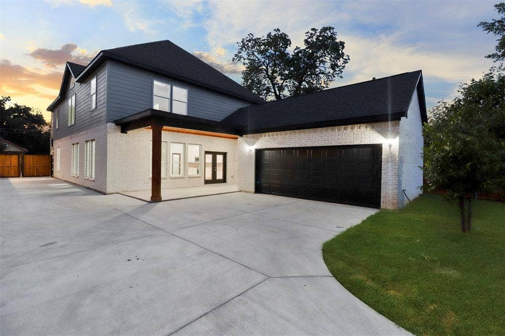 4112 Balch Drive, Dallas, TX 75216 Modern two-story home featuring a striking black and white exterior with clean architectural lines