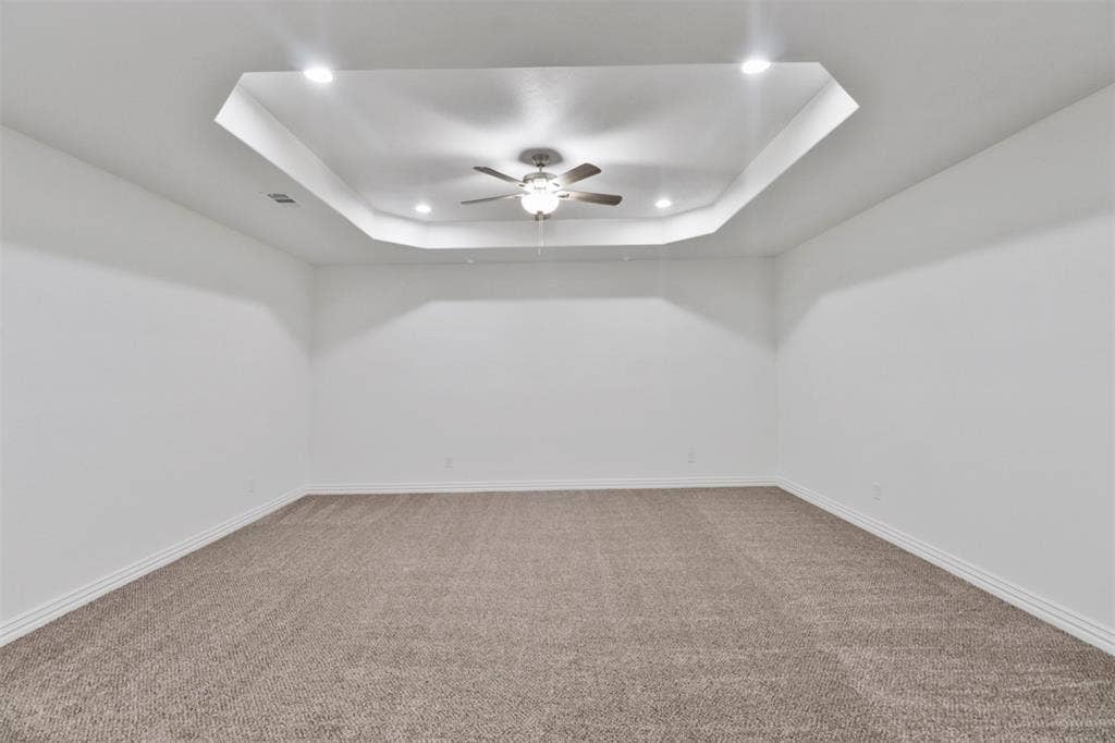 4112 Balch Drive, Dallas, TX 75216 Spacious room featuring fresh white walls, neutral carpet flooring, and a modern recessed ceiling with integrated ceiling fan and recessed lighting throughout