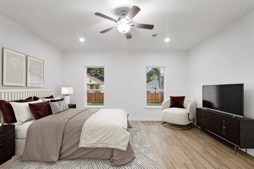 4112 Balch Drive, Dallas, TX 75216 Spacious bedroom with wood-finish flooring, two windows, recessed lighting, and a ceiling fan
