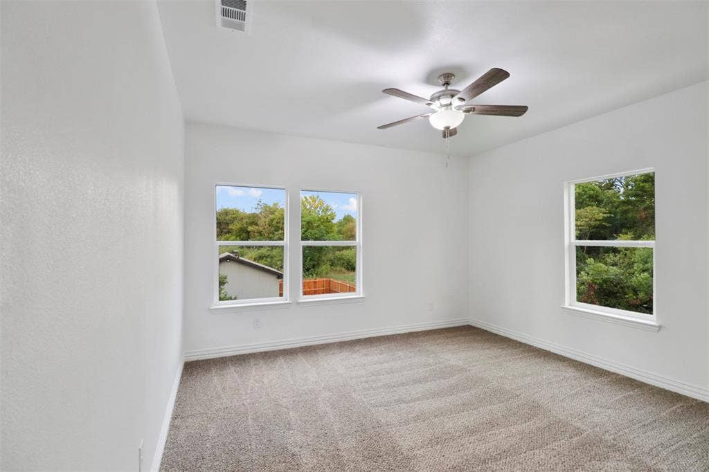 4112 Balch Drive, Dallas, TX 75216 Bright interior space featuring light-toned carpeting and white painted walls