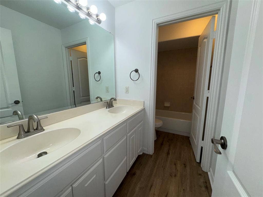 1913 Lawnview Drive, McKinney, TX 75072 Dual-sink vanity with white cabinetry, undermount basins, and brushed nickel hardware