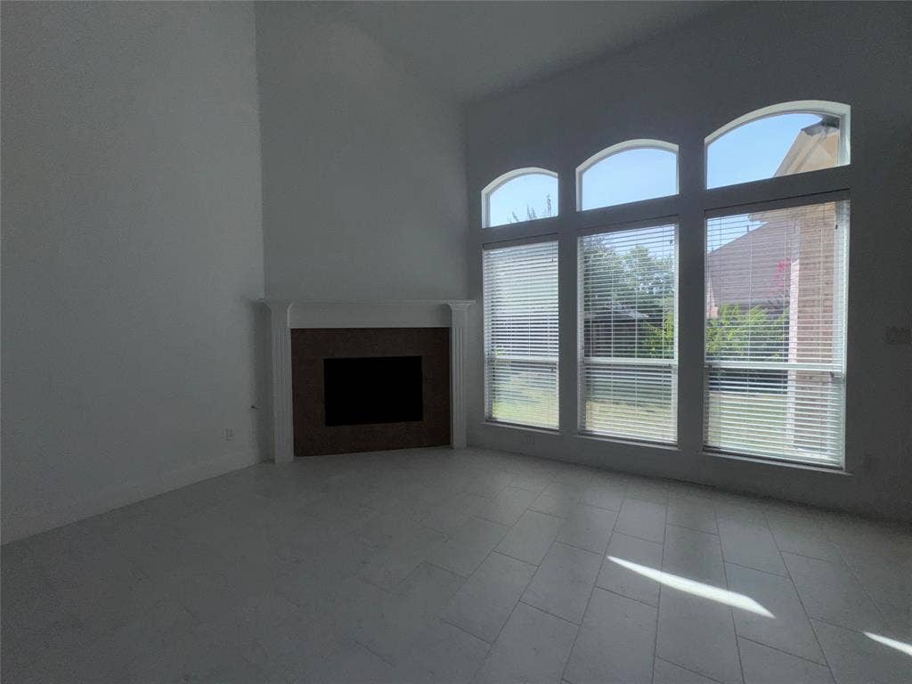 1913 Lawnview Drive, McKinney, TX 75072 Vaulted ceilings over a fireplace with a traditional mantel and hearth