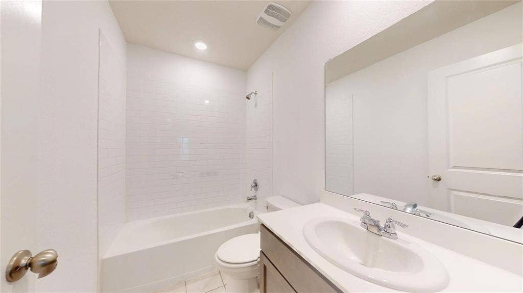 717 Cottonwood Way, Royse City, TX 75189 Bathroom featuring a white subway tile surround shower and tub combination