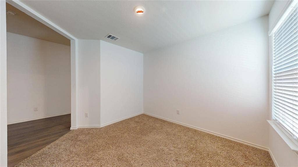 717 Cottonwood Way, Royse City, TX 75189 Neutral wall finishes with a window featuring horizontal blinds