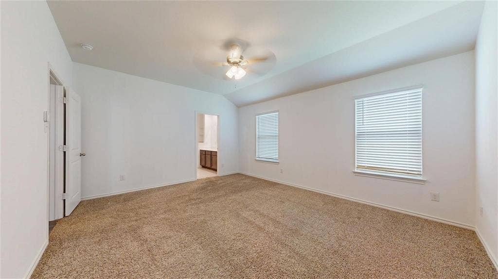 717 Cottonwood Way, Royse City, TX 75189 Carpeted room with vaulted ceilings and a ceiling fan with integrated lighting
