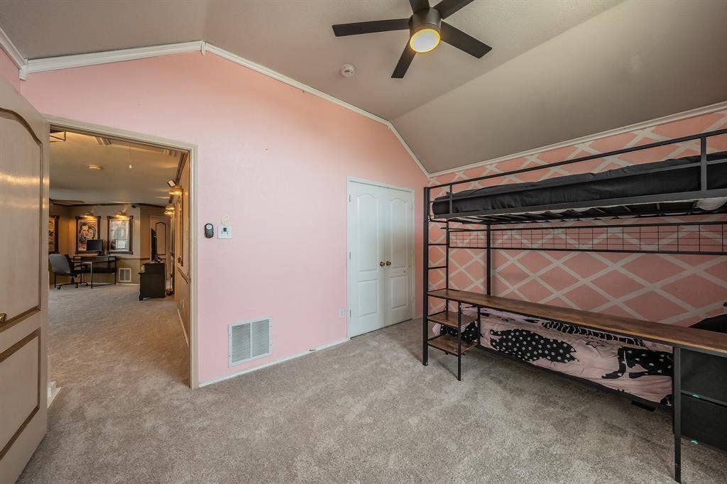 812 Chaparral Drive, Grand Prairie, TX 75052 Carpeted room with a vaulted ceiling and a ceiling fan