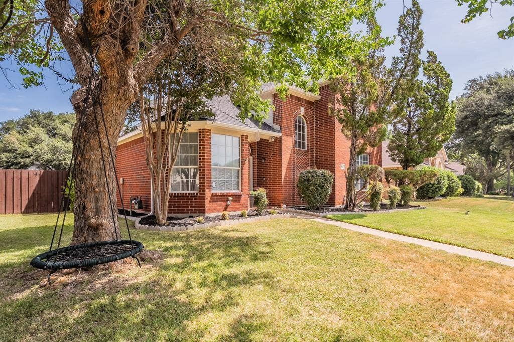 812 Chaparral Drive, Grand Prairie, TX 75052 Brick exterior residence featuring a prominent bay window