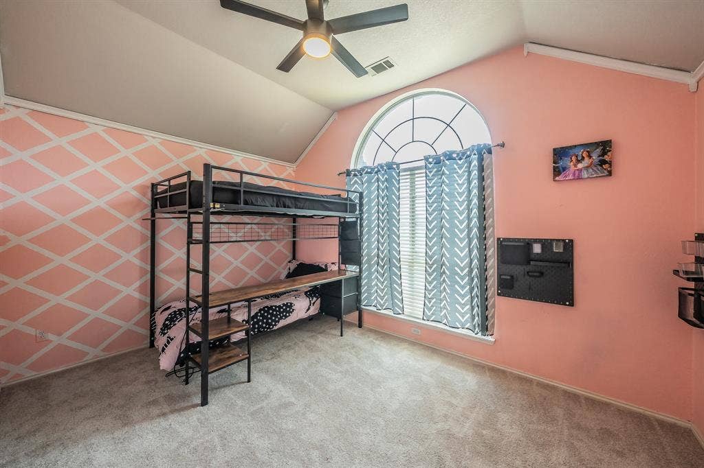 812 Chaparral Drive, Grand Prairie, TX 75052 Room featuring a vaulted ceiling, a large arched window with grid detailing, and light-colored carpeting