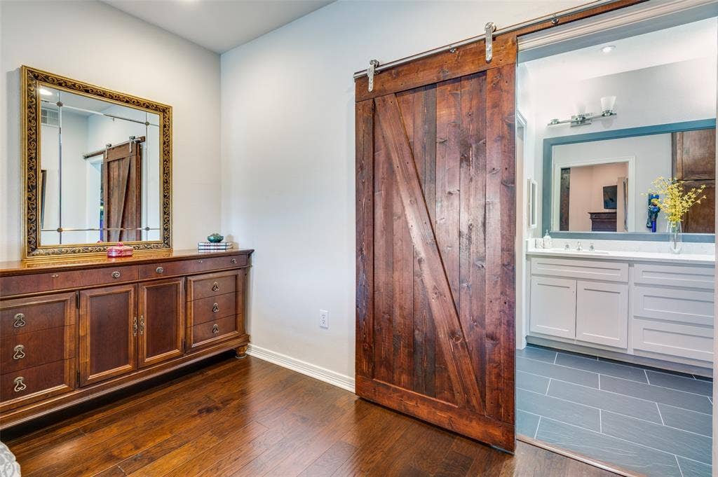 330 Las Colinas Boulevard E, #1016, Irving, TX 75039 Barn door separating primary bedroom and ensuite primary bathroom