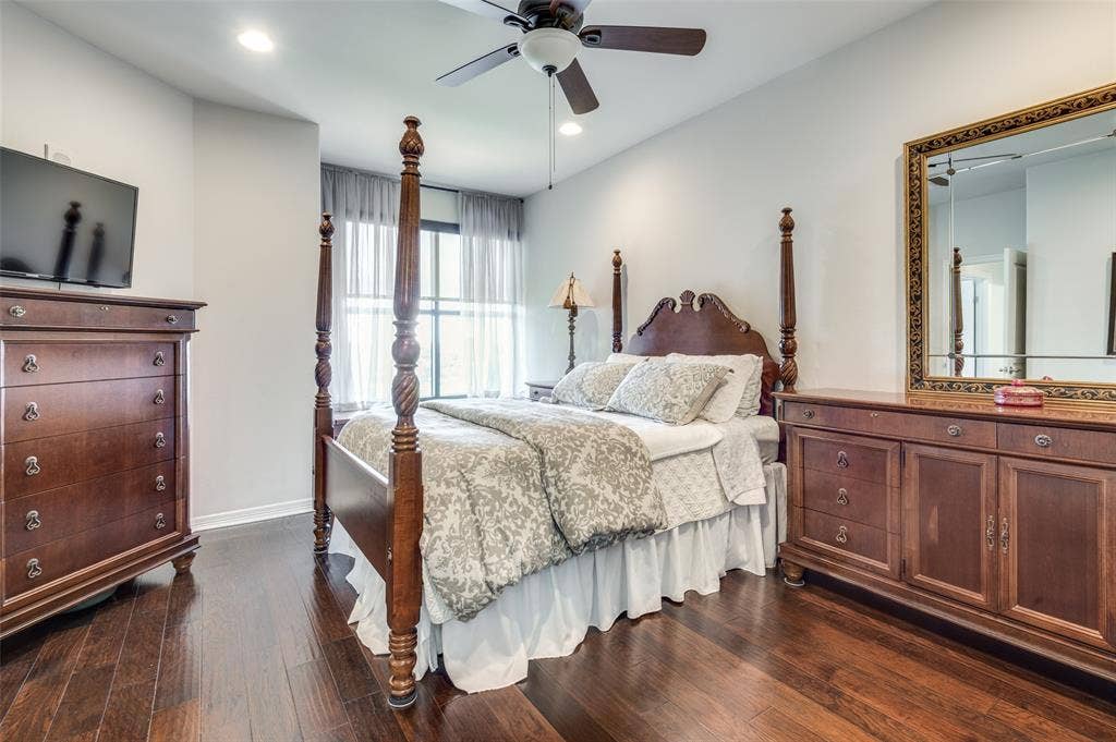 330 Las Colinas Boulevard E, #1016, Irving, TX 75039 Primary bedroom with large window highlights wood floors