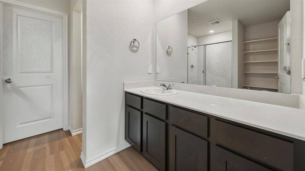3057 Hidden Valley Drive, Lindale, TX 75771 Bathroom featuring an extended vanity with dark wood-finish cabinetry and a light-toned countertop