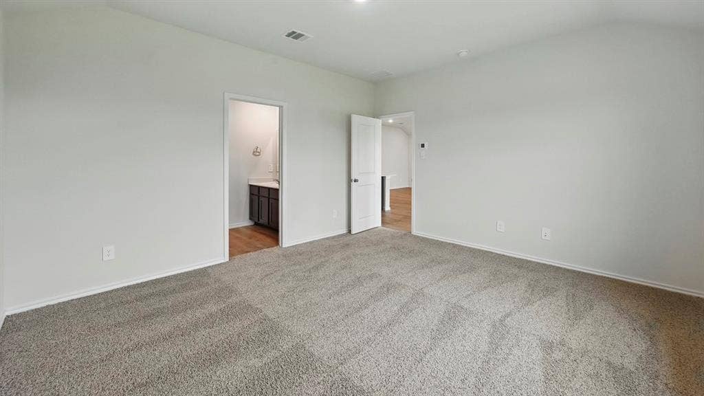 3057 Hidden Valley Drive, Lindale, TX 75771 Spacious room featuring neutral carpeting, light-toned walls, and an overhead light fixture