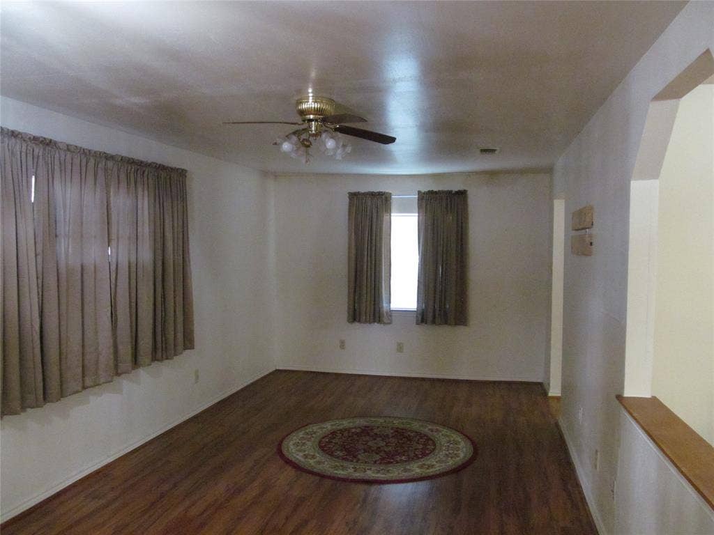 740 Emberwood Drive, Dallas, TX 75232 Wood-finish flooring with an arched doorway and a ceiling fan FAMILY ROOM OR DEN