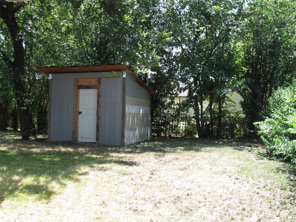 740 Emberwood Drive, Dallas, TX 75232 REAR RIGHT VIEW OF THE BACK YARD WITH HAND BUILT SHED VIEW - THERE IS AN ALLEY WAY BEHIND THE FENCE