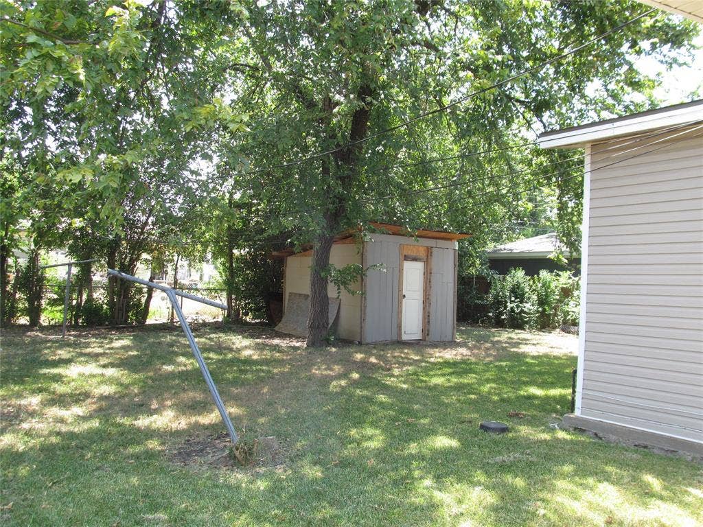 740 Emberwood Drive, Dallas, TX 75232 LEFT REAR VIEW OF THE BACK YARD WITH VIEW OF HAND BUILT SHED