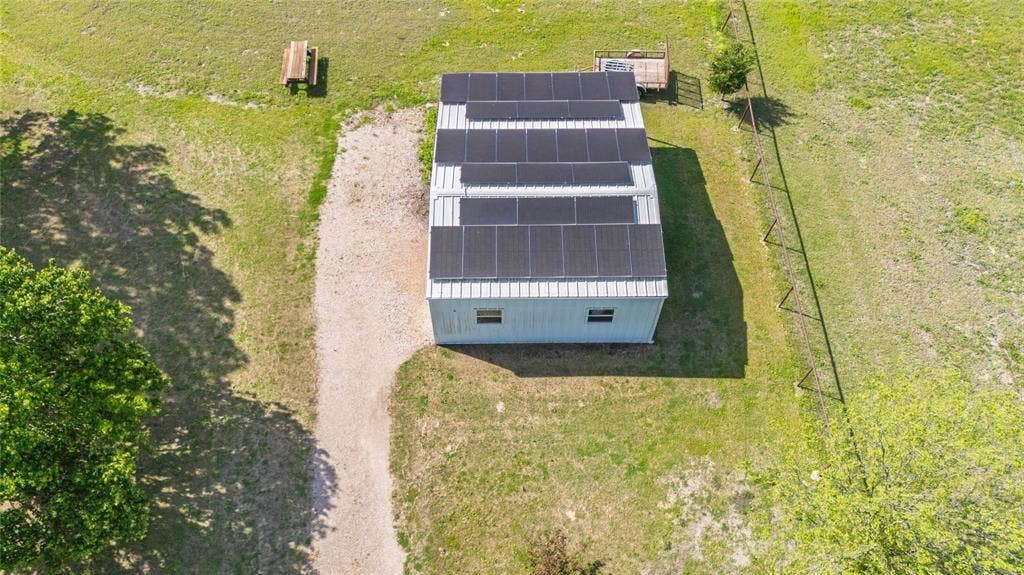 Building with a metal roof featuring multiple solar panel arrays