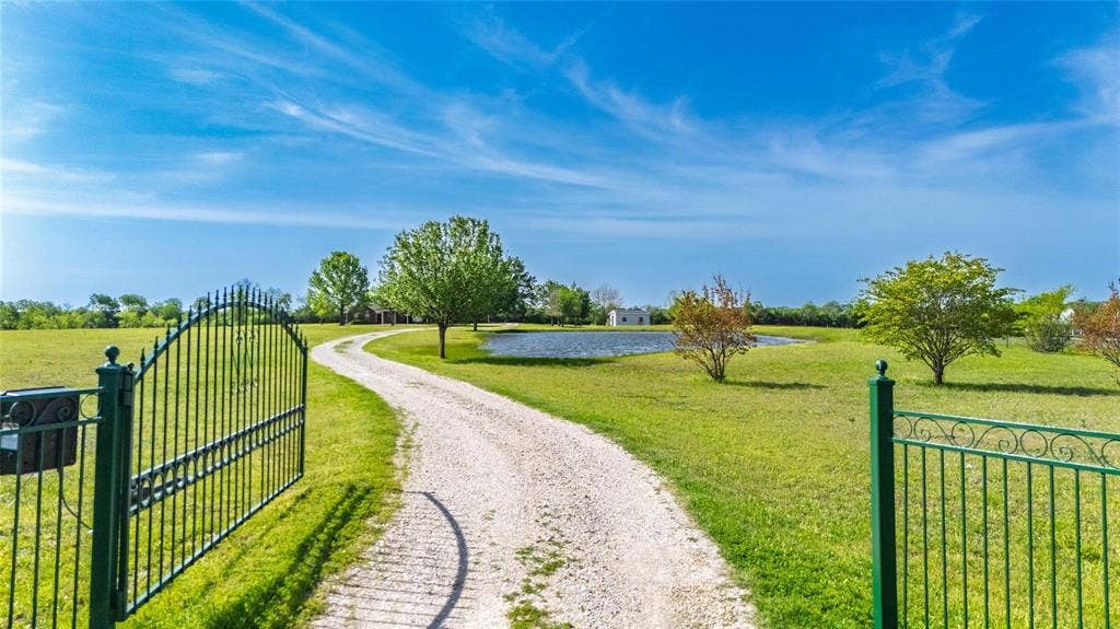 Gated entry with wrought iron fencing
