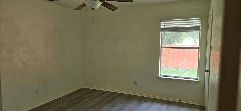 4809 Orchard Ridge Drive, Garland, TX 75043 Interior space featuring wood-finish flooring, a ceiling fan with light fixture, and a window with blinds
