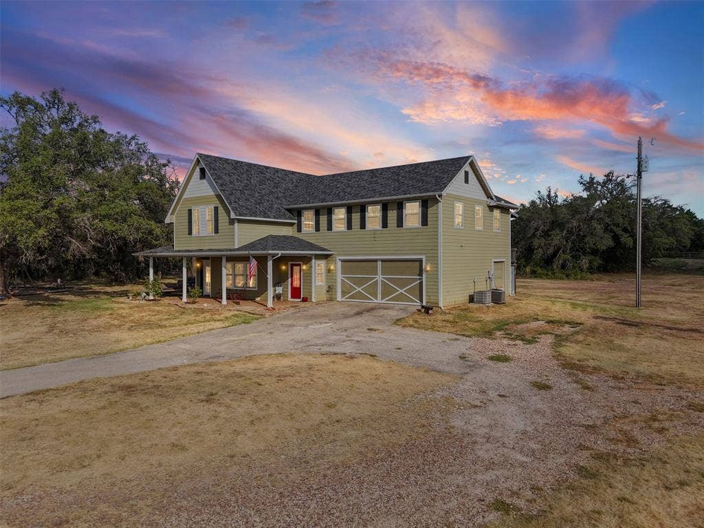 325 Bolton Road, Granbury, TX 76049 Two-story home with light green siding and dark roof