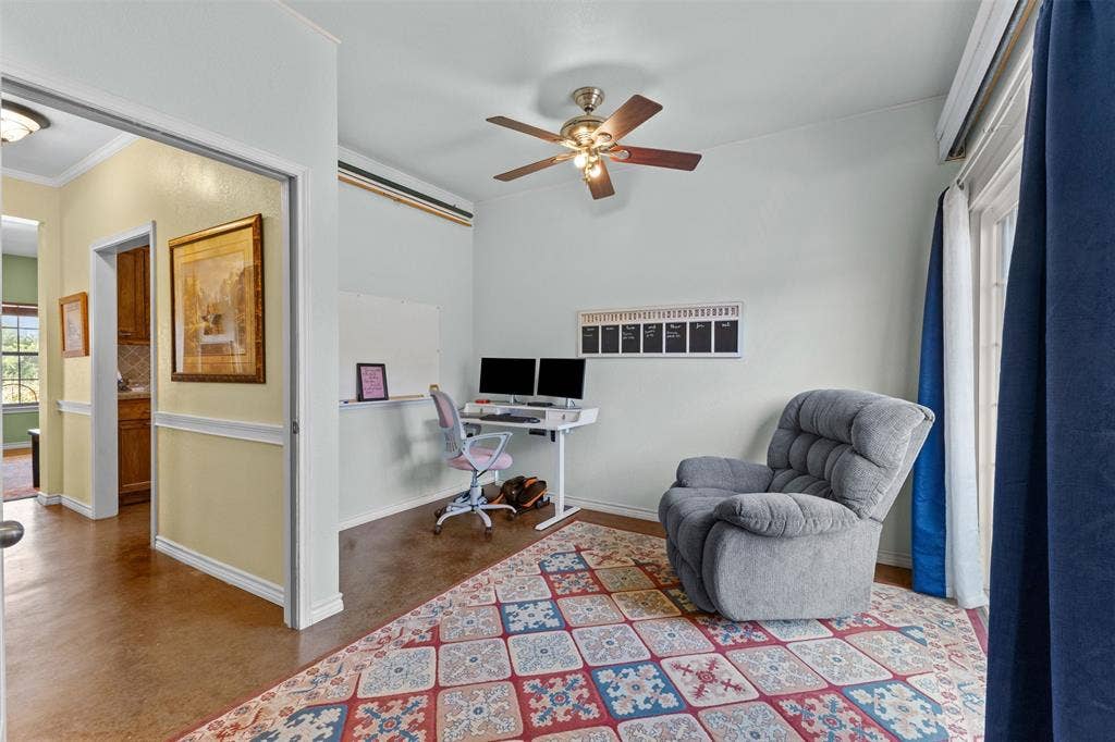 325 Bolton Road, Granbury, TX 76049 Private office/flex room with built-in desk space, ceiling fan, and a door to the side yard. Works as a home office or a quiet sitting room.