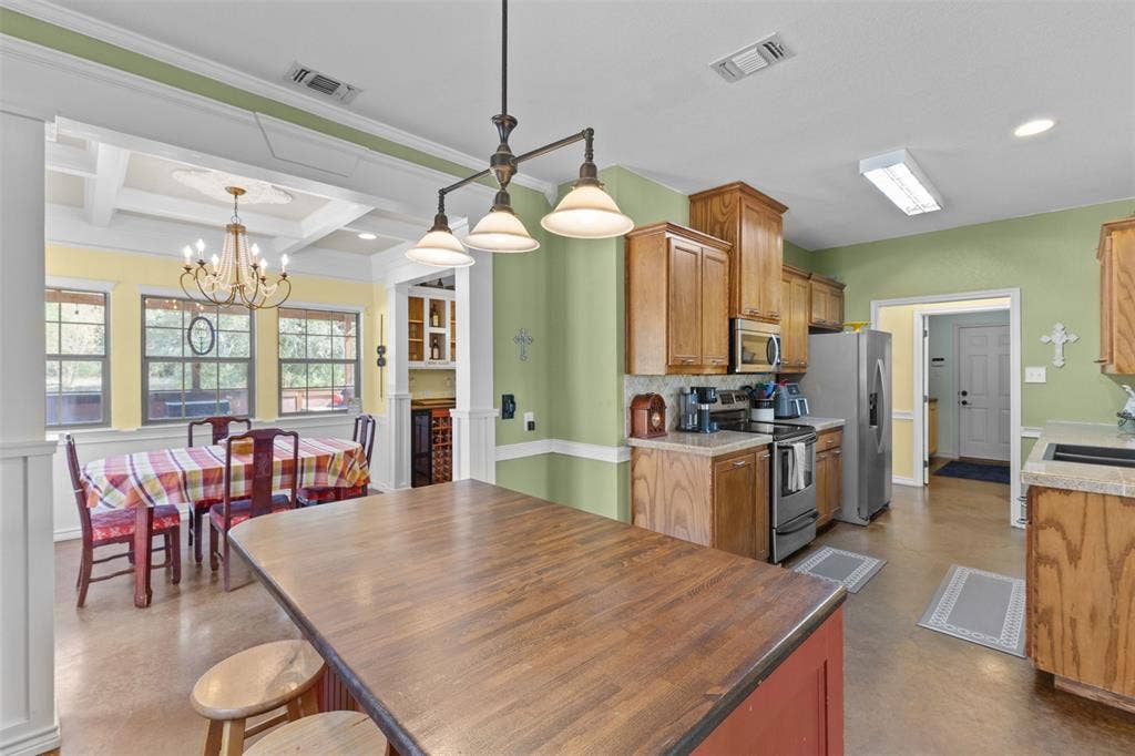 325 Bolton Road, Granbury, TX 76049 Kitchen featuring wood cabinetry, stainless steel appliances, and a central island with wood countertop