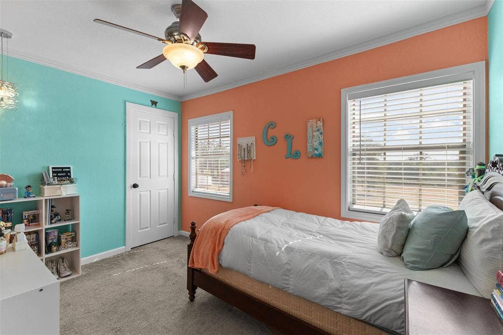 325 Bolton Road, Granbury, TX 76049 Ceiling fan with integrated lighting, window with blinds, paneled interior door, and wall-to-wall carpeting