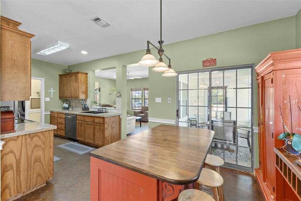 325 Bolton Road, Granbury, TX 76049 Kitchen featuring wood cabinetry, light-toned countertops, and a full suite of appliances