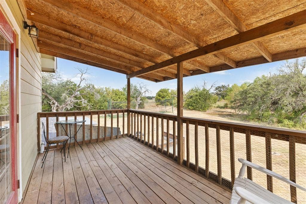 325 Bolton Road, Granbury, TX 76049 Expansive covered wood deck with wood-plank flooring and a wooden railing