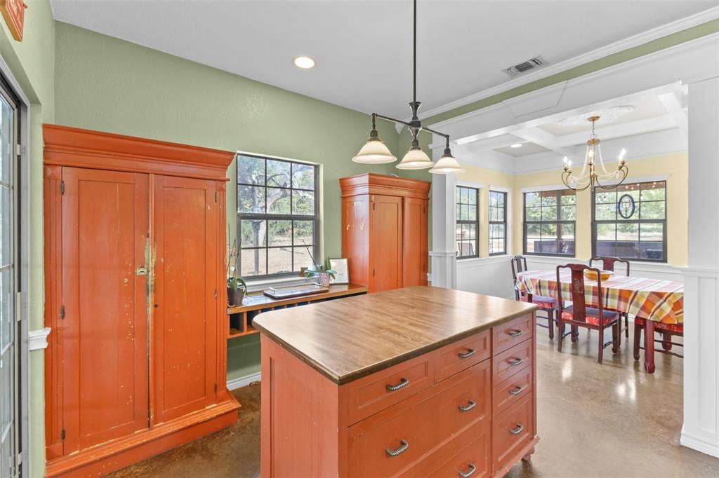 325 Bolton Road, Granbury, TX 76049 Kitchen island with wood-finish countertop and drawers