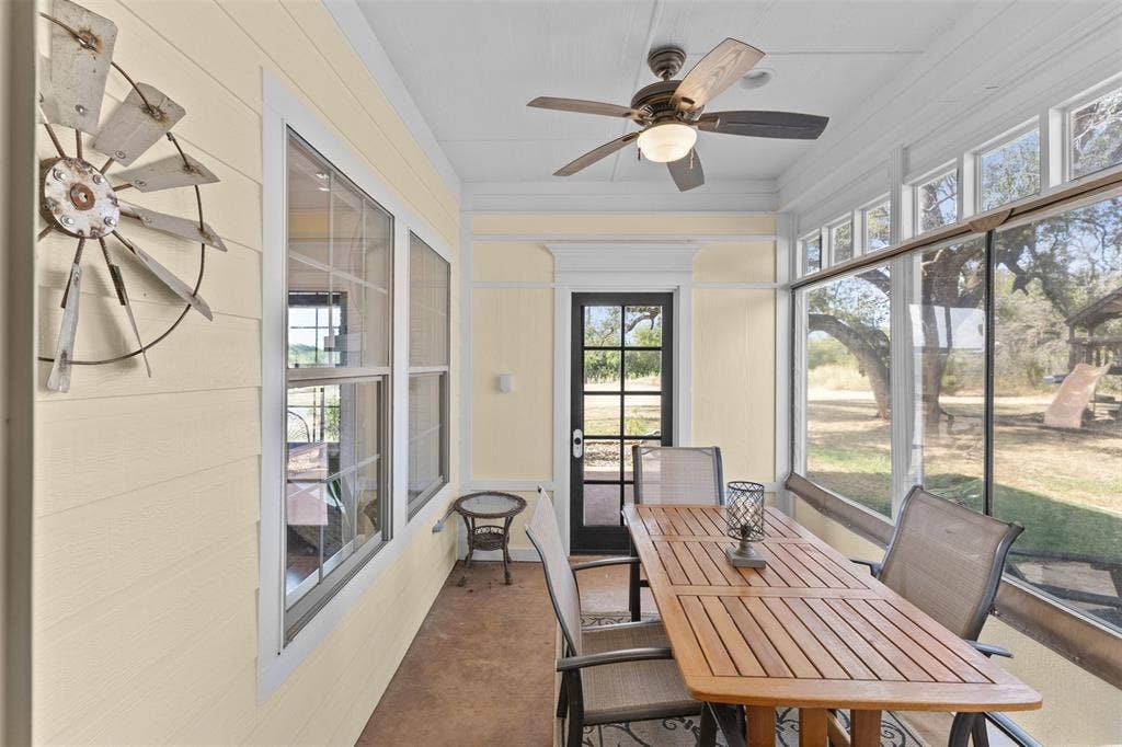 325 Bolton Road, Granbury, TX 76049 Screened sunroom off the kitchen with a ceiling fan and room for a full dining set, a shaded spot to enjoy the acreage without the bugs or the sun. Removable Eisenglass for true year-round usability.