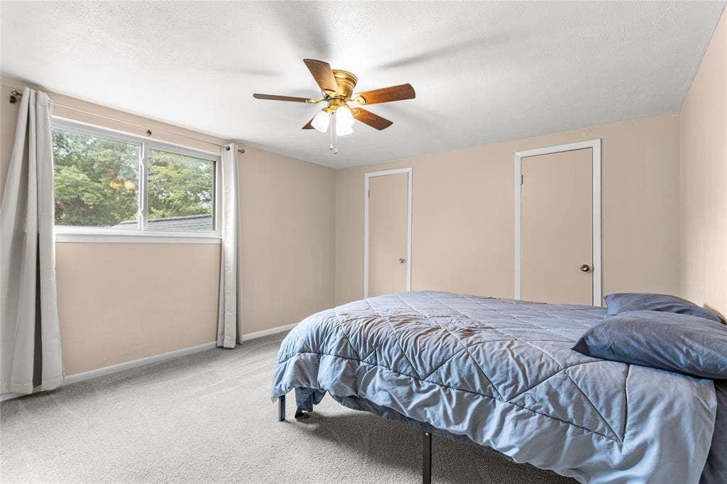 6930 Trailcrest Drive, Dallas, TX 75232 Spacious room featuring light-colored walls, soft carpeting, and a ceiling fan with integrated lighting