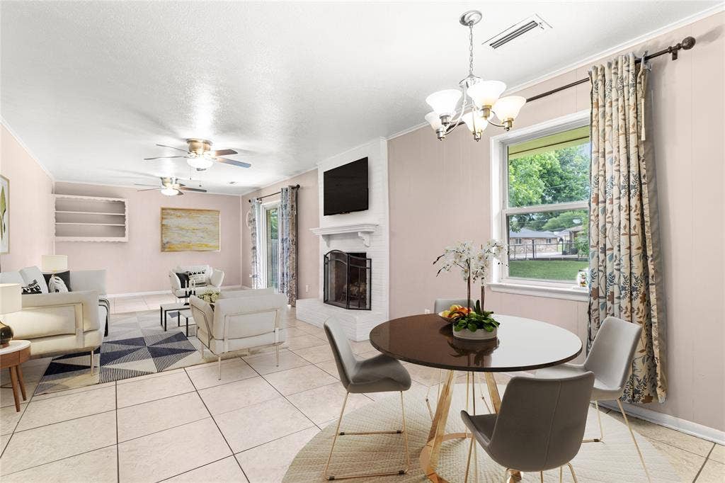 6930 Trailcrest Drive, Dallas, TX 75232 Virtually Staged Expansive open-concept living area featuring tile flooring, a white brick fireplace with a mantel, built-in shelving, and multiple windows allowing natural light