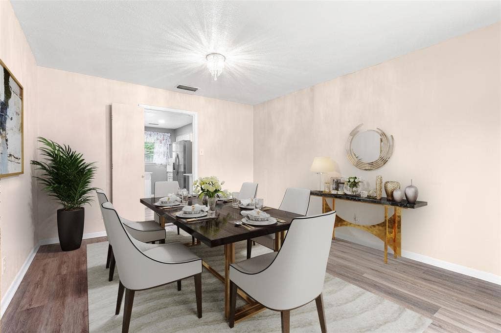 6930 Trailcrest Drive, Dallas, TX 75232 Virtually Staged Formal dining area featuring wood-finish flooring, a contemporary chandelier, and an open doorway to the kitchen