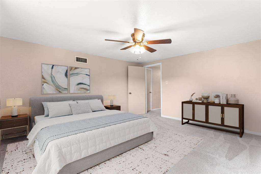 6930 Trailcrest Drive, Dallas, TX 75232 Virtually Staged Spacious bedroom featuring light-colored walls, ceiling fan with integrated lighting, and soft carpeting