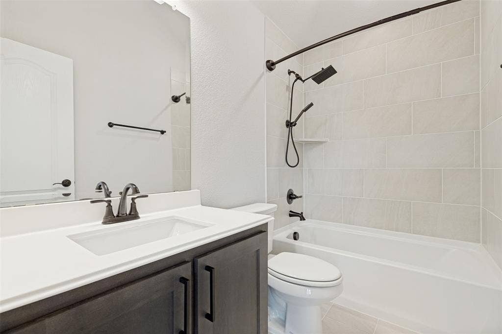 5405 Pooley Lane, McKinney, TX 75071 Bathroom featuring a single vanity with a white countertop and dark wood-finish cabinetry