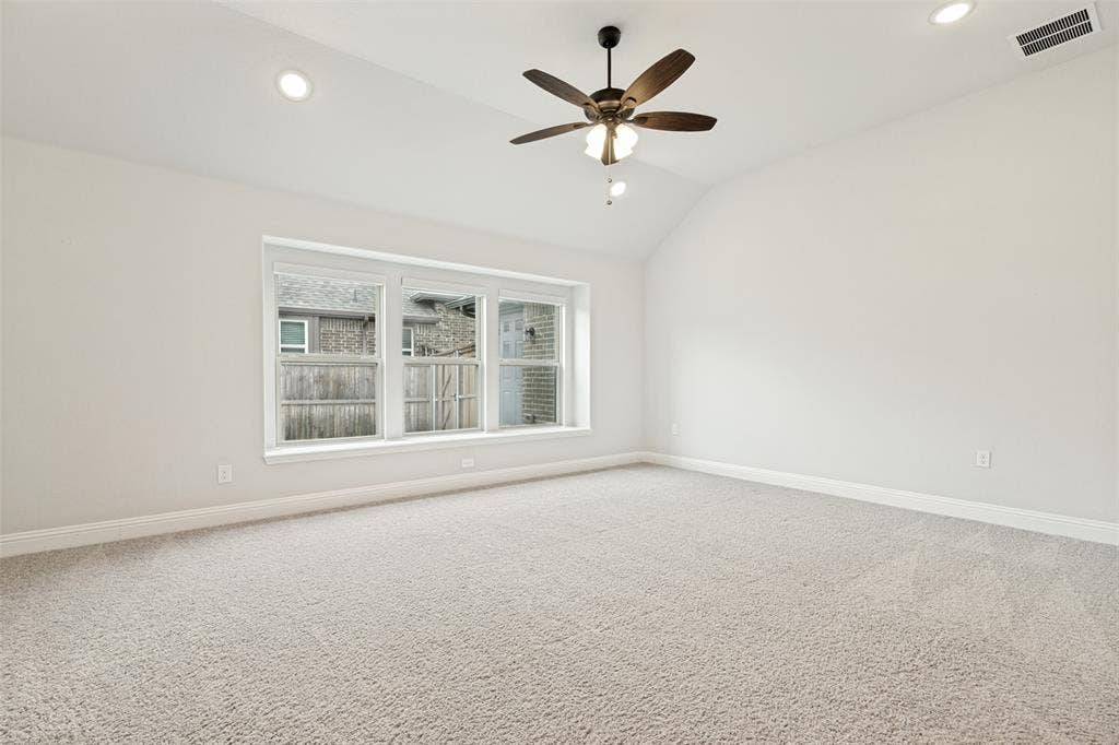5405 Pooley Lane, McKinney, TX 75071 Carpeted room featuring a vaulted ceiling with a ceiling fan, recessed lighting, and a triple window unit with white trim