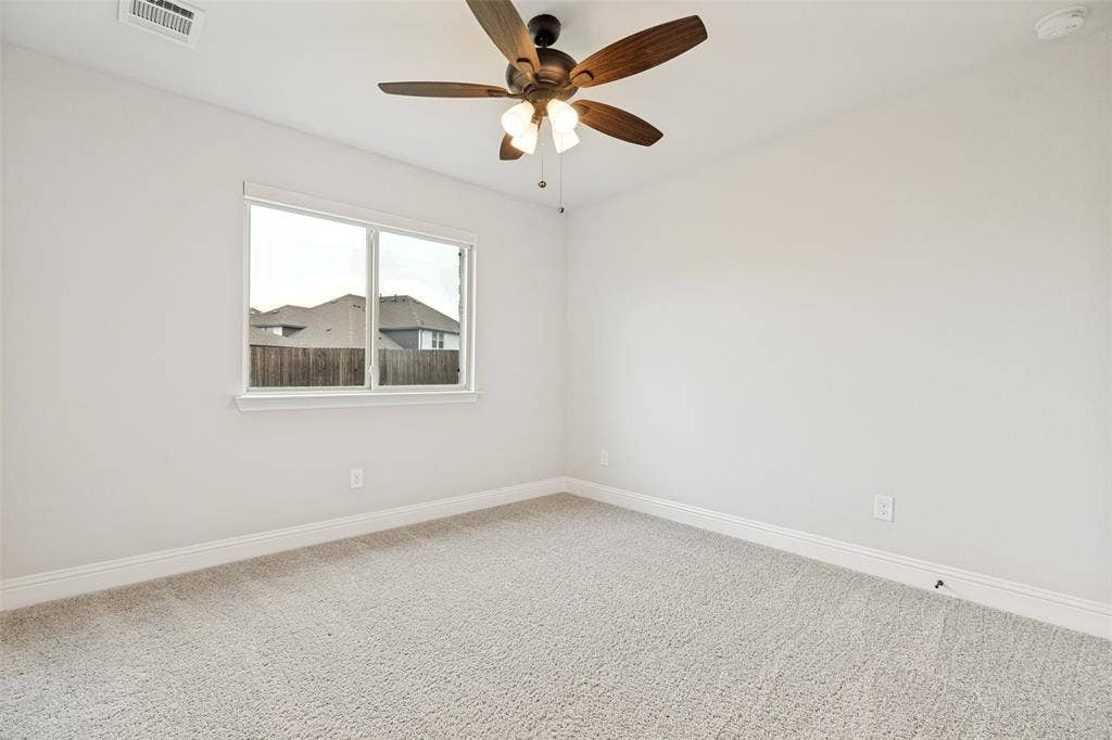 5405 Pooley Lane, McKinney, TX 75071 Carpeted room featuring a ceiling fan with integrated lighting, a single window, and white baseboards