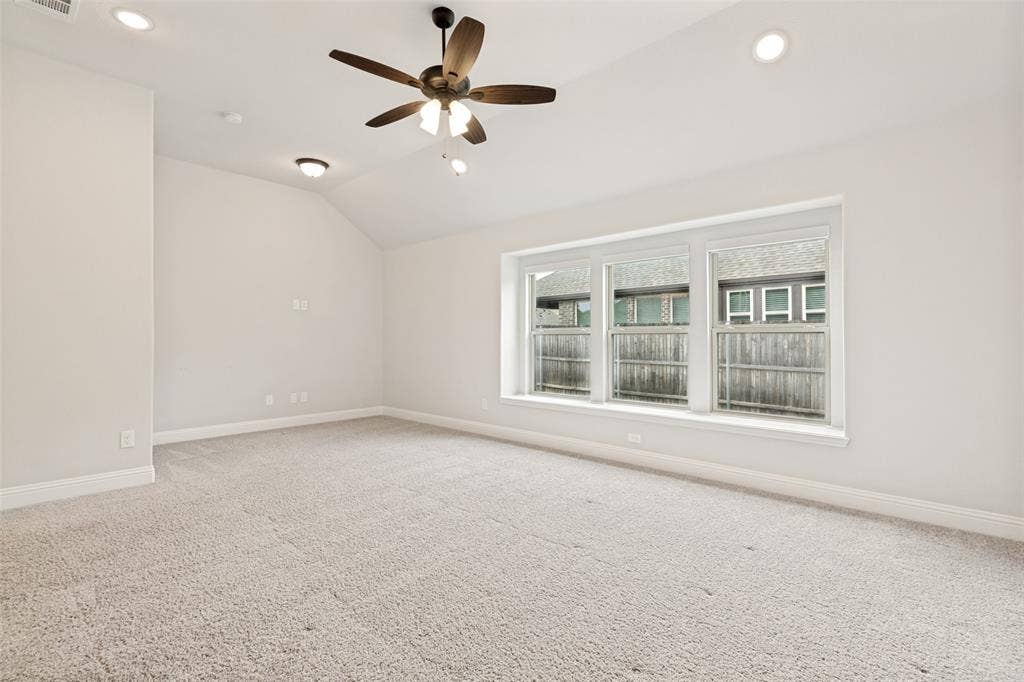 5405 Pooley Lane, McKinney, TX 75071 Spacious room featuring vaulted ceilings, recessed lighting, and a ceiling fan with integrated lighting