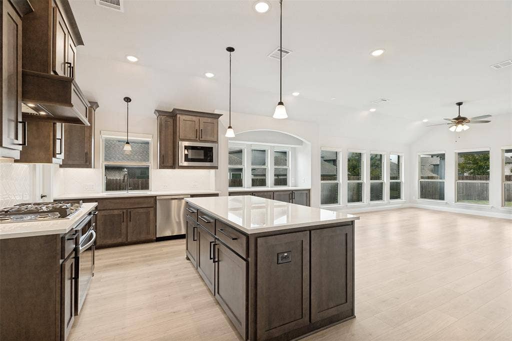 5405 Pooley Lane, McKinney, TX 75071 Open-concept kitchen featuring an island, recessed lighting, and wood-finish flooring