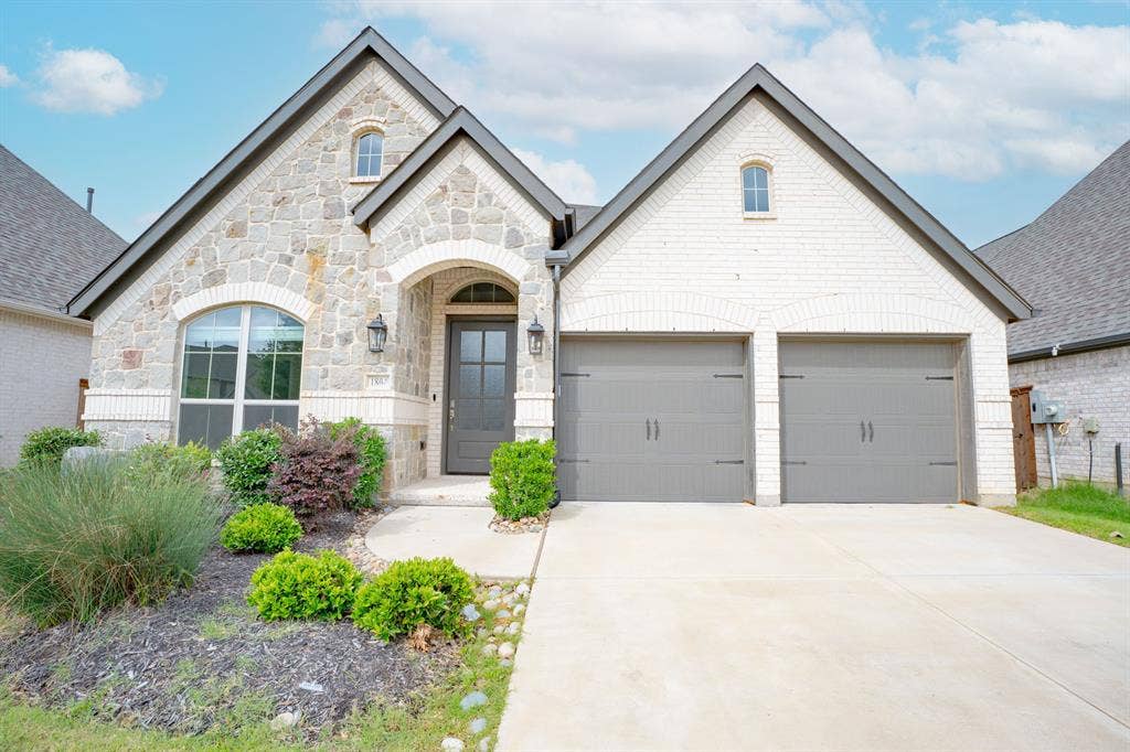 Stone and brick exterior with arched windows and entry