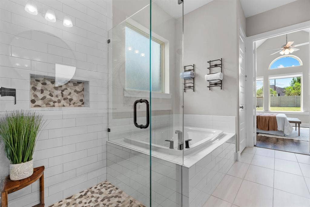 1821 Stonewall Road, Argyle, TX 76226 Glass-enclosed shower with pebble-tile floor and recessed shelf